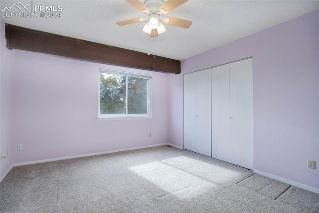 unfurnished bedroom featuring light carpet, a closet, and ceiling fan