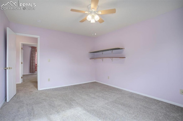 unfurnished room featuring light carpet and ceiling fan