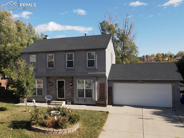 front facade featuring a garage and a front lawn