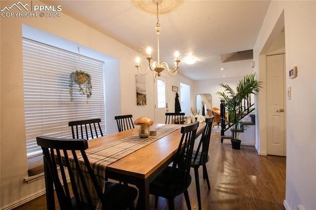 dining space featuring dark hardwood / wood-style floors and an inviting chandelier