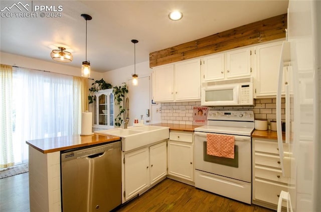 kitchen with dark wood-type flooring, white cabinetry, hanging light fixtures, and white appliances