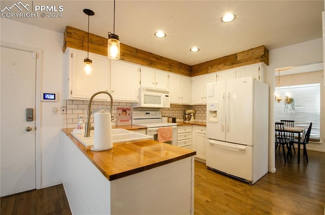 kitchen featuring white cabinetry, kitchen peninsula, hardwood / wood-style flooring, and white appliances