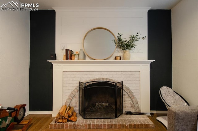 details with hardwood / wood-style flooring and a fireplace