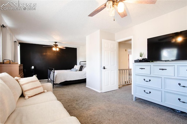 bedroom with ceiling fan, a textured ceiling, and light colored carpet