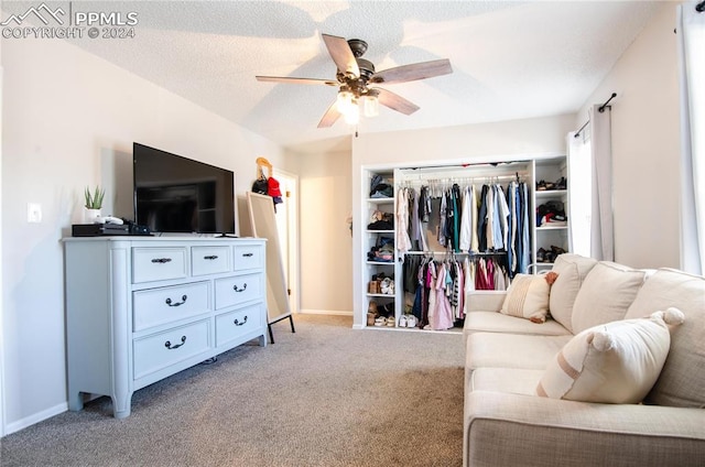 bedroom featuring a closet, ceiling fan, a textured ceiling, and light colored carpet