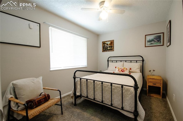 carpeted bedroom with a textured ceiling and ceiling fan