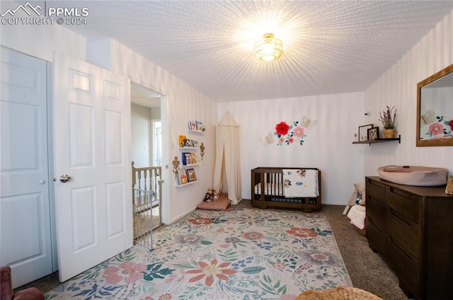 bedroom with carpet and a textured ceiling