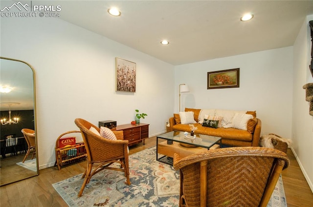 living room featuring a notable chandelier and wood-type flooring