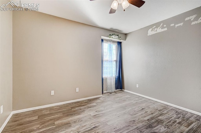 spare room with ceiling fan and wood-type flooring