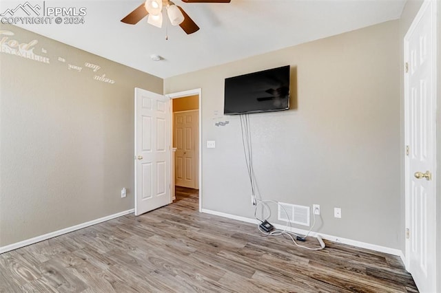 unfurnished bedroom featuring ceiling fan and light hardwood / wood-style flooring