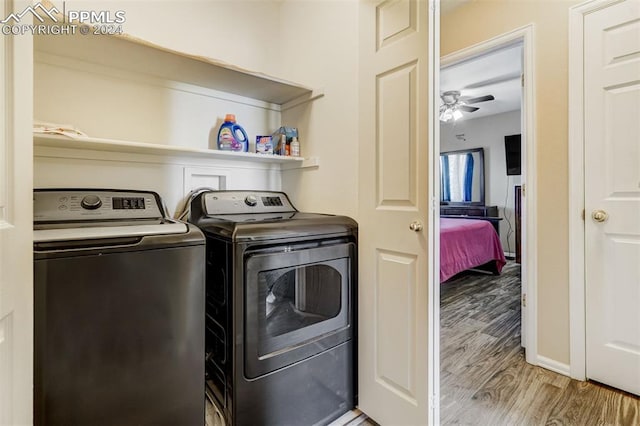 laundry area featuring washer and dryer, wood-type flooring, and ceiling fan