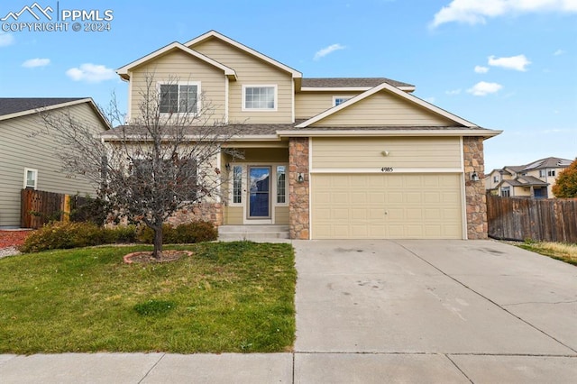 view of front of property with a garage and a front lawn