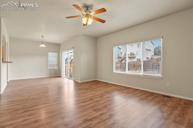 empty room with ceiling fan and wood-type flooring