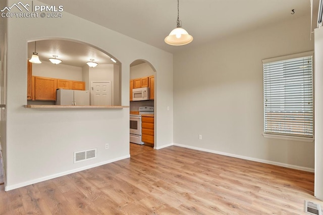 unfurnished living room featuring light hardwood / wood-style flooring