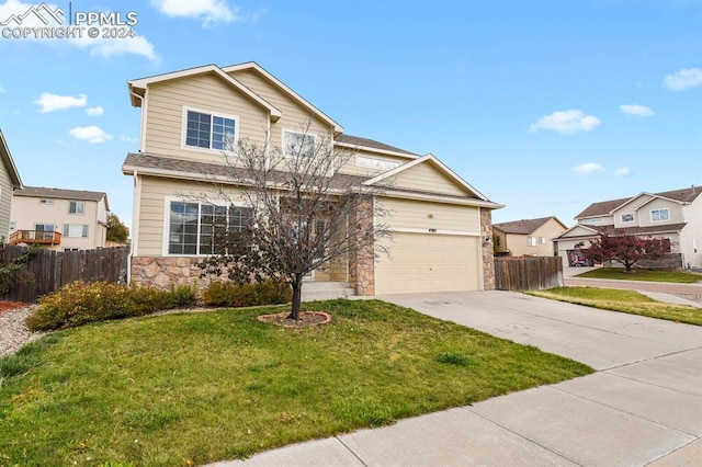 view of front of property featuring a front lawn and a garage