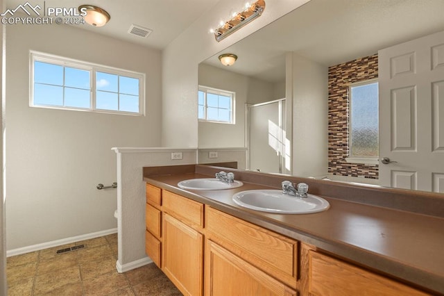 bathroom with vanity and a shower with door