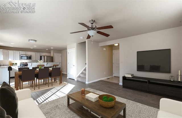 living room with hardwood / wood-style floors and ceiling fan