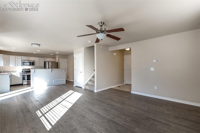 unfurnished living room featuring hardwood / wood-style flooring and ceiling fan