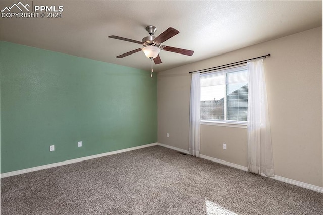 carpeted spare room with ceiling fan