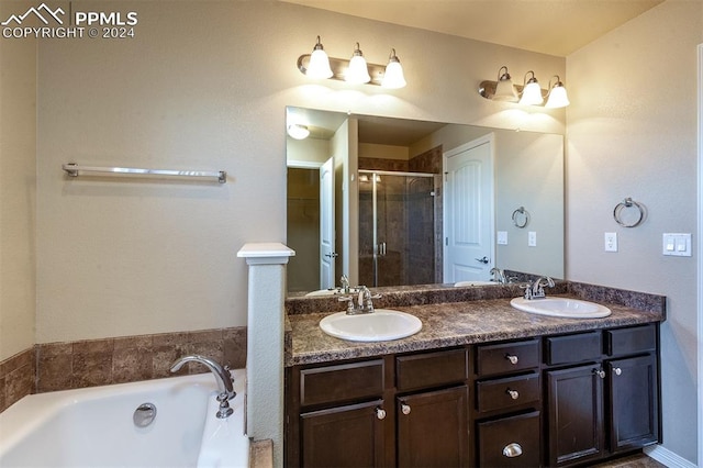 bathroom featuring plus walk in shower and vanity