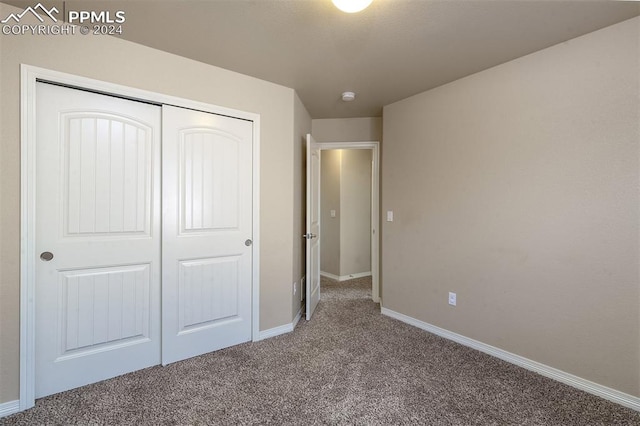 unfurnished bedroom featuring carpet flooring and a closet