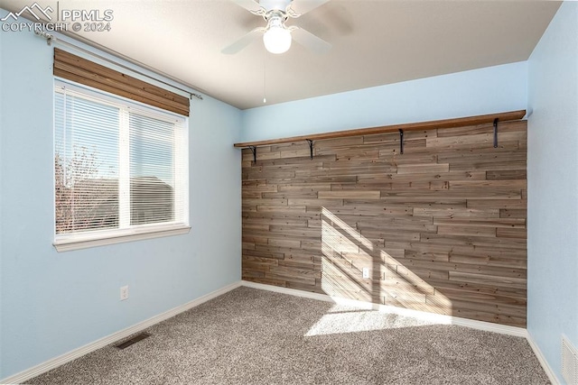 spare room featuring ceiling fan and carpet