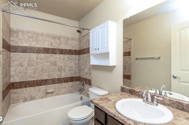 full bathroom featuring toilet, vanity, and tiled shower / bath