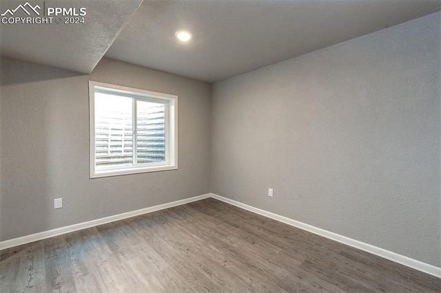 unfurnished room with hardwood / wood-style floors