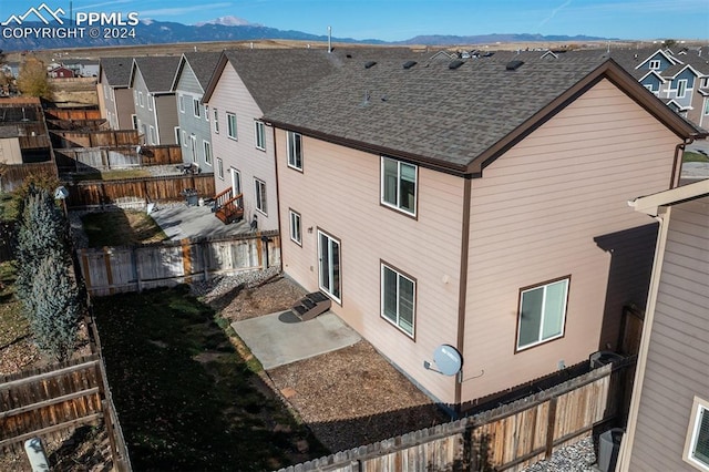 view of building exterior featuring a mountain view and central AC