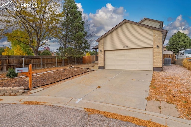 view of home's exterior featuring cooling unit and a garage