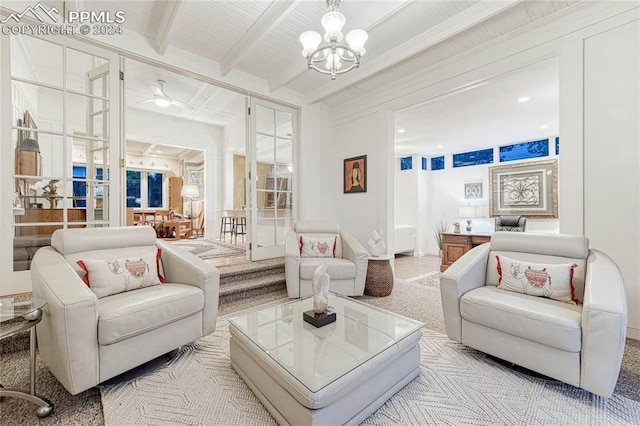 living room with light carpet, beamed ceiling, and a chandelier