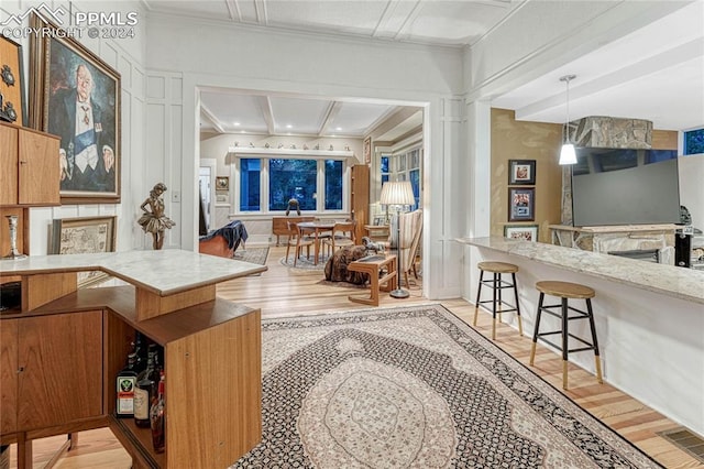 interior space featuring a fireplace, light hardwood / wood-style flooring, and crown molding