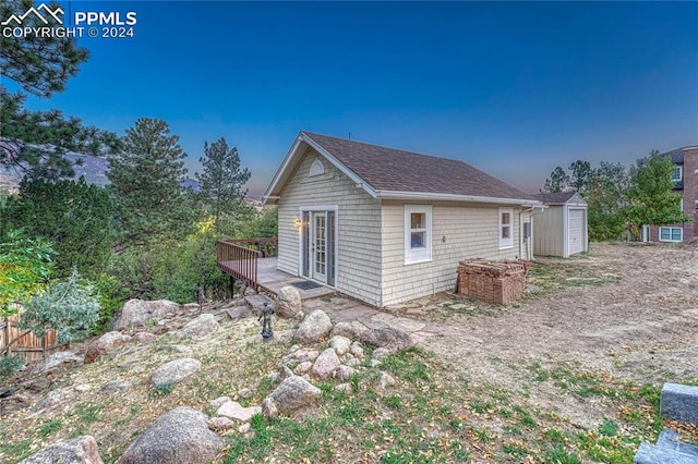 view of home's exterior featuring a storage shed and a deck