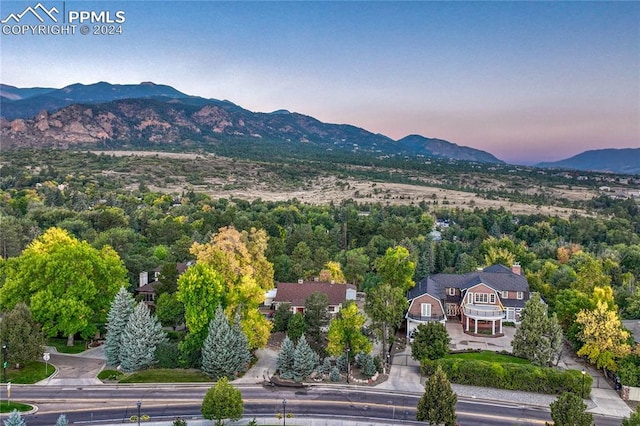 aerial view at dusk featuring a mountain view