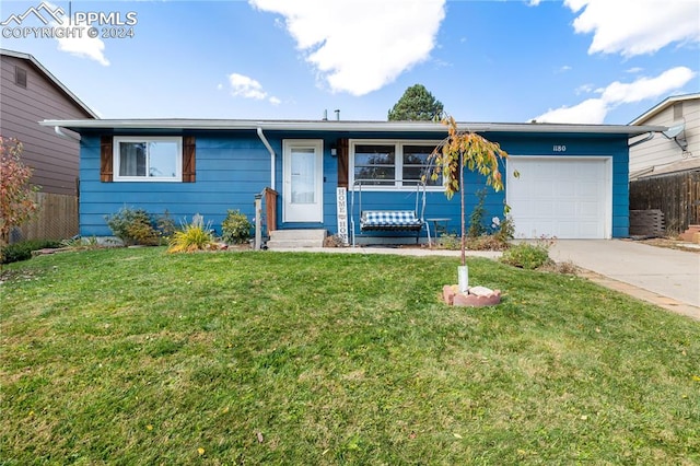 ranch-style home with a front yard and a garage