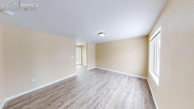 spare room with hardwood / wood-style flooring