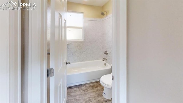 bathroom featuring hardwood / wood-style floors, shower / bathing tub combination, and toilet