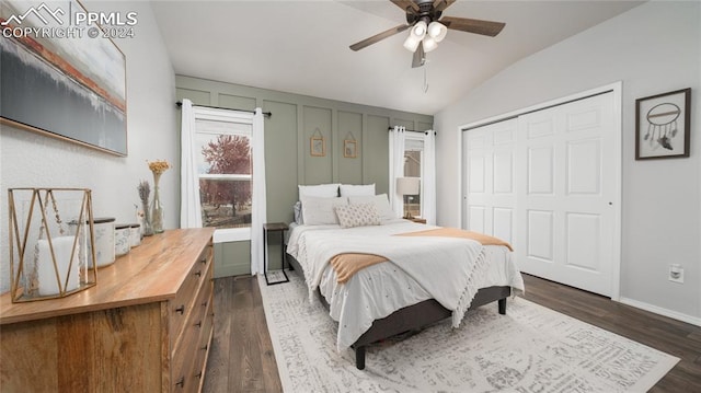 bedroom with a closet, ceiling fan, lofted ceiling, and dark hardwood / wood-style flooring