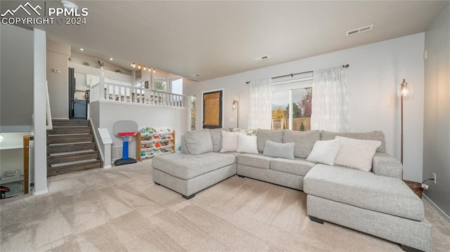 carpeted living room featuring lofted ceiling and a wealth of natural light