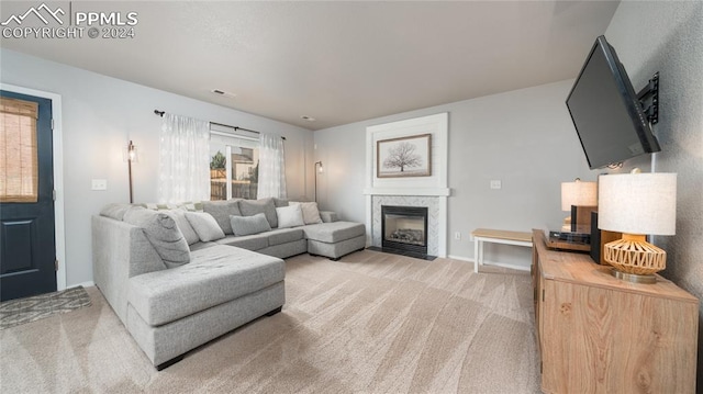 living room with carpet and a high end fireplace