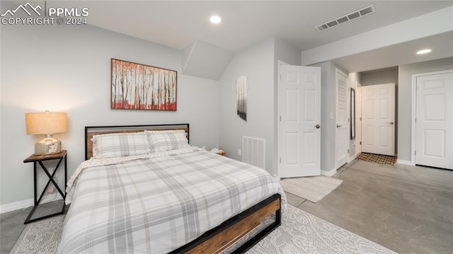 bedroom featuring concrete flooring