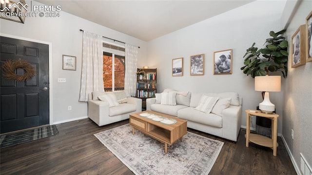 living room with dark hardwood / wood-style flooring