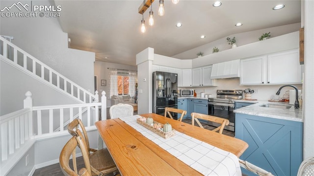 dining space with lofted ceiling and sink