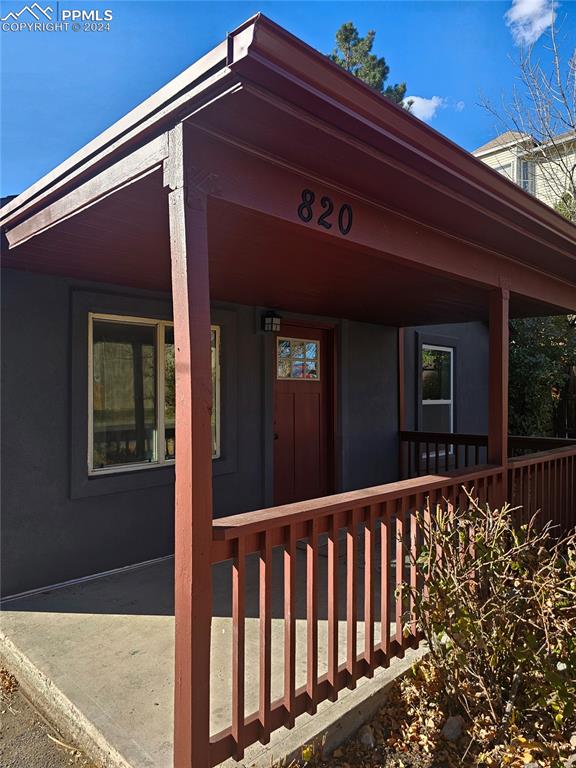 view of exterior entry featuring covered porch