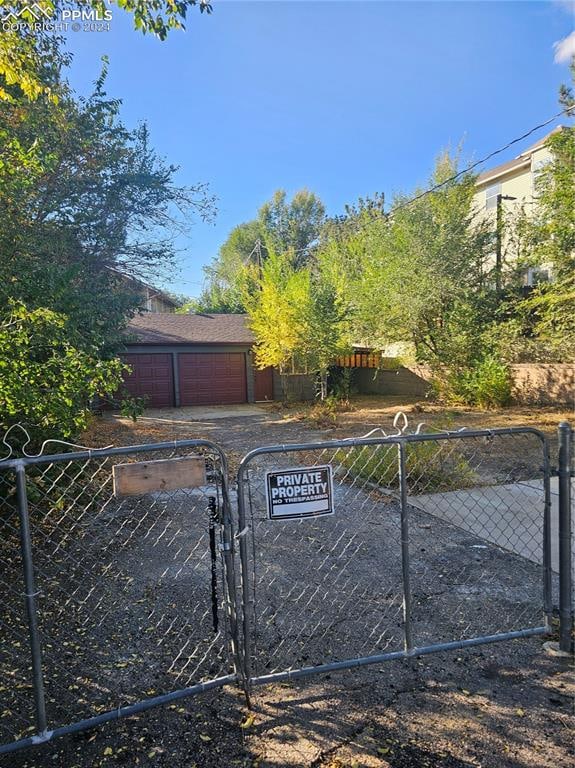 view of gate with a garage