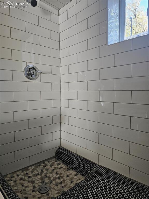 bathroom with tiled shower