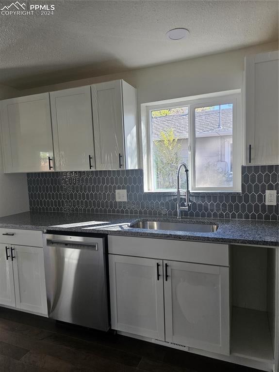 kitchen featuring dishwasher, dark wood-type flooring, sink, and white cabinets