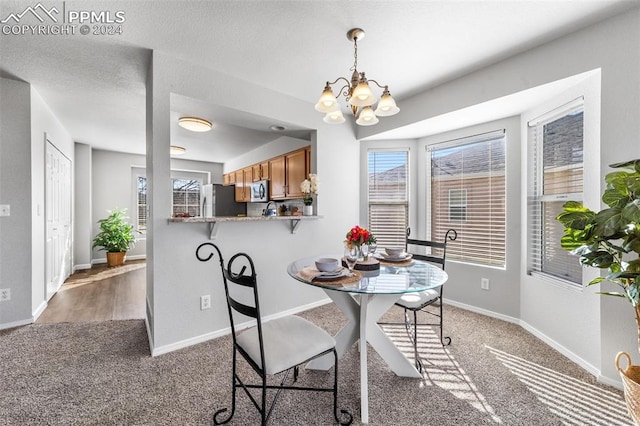 carpeted dining space with an inviting chandelier