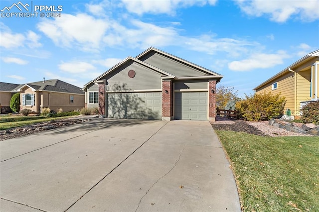 view of front of house featuring a garage and a front yard