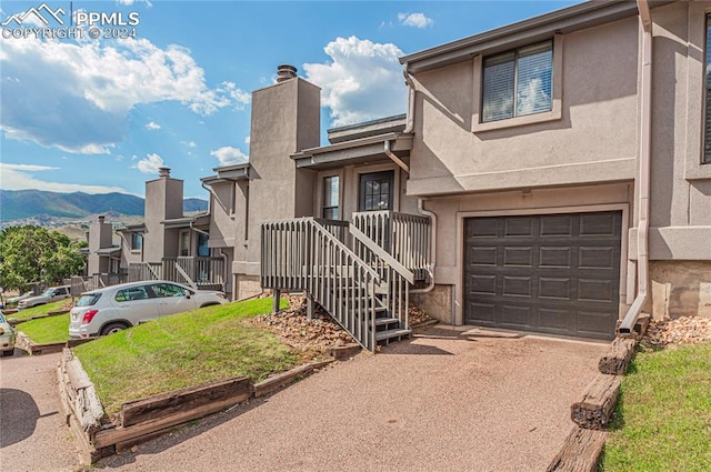 view of front of property featuring a mountain view and a garage